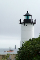 Fishing Boat Passes by Portsmouth Light on Overcast Day